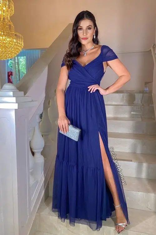 Look com vestido azul marinho e acessórios prateados