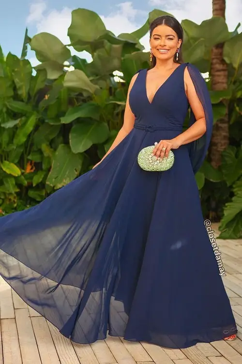 Look com vestido azul marinho e clutch verde