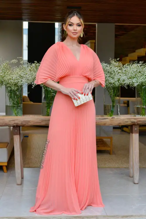 Vestido coral com acessórios dourados